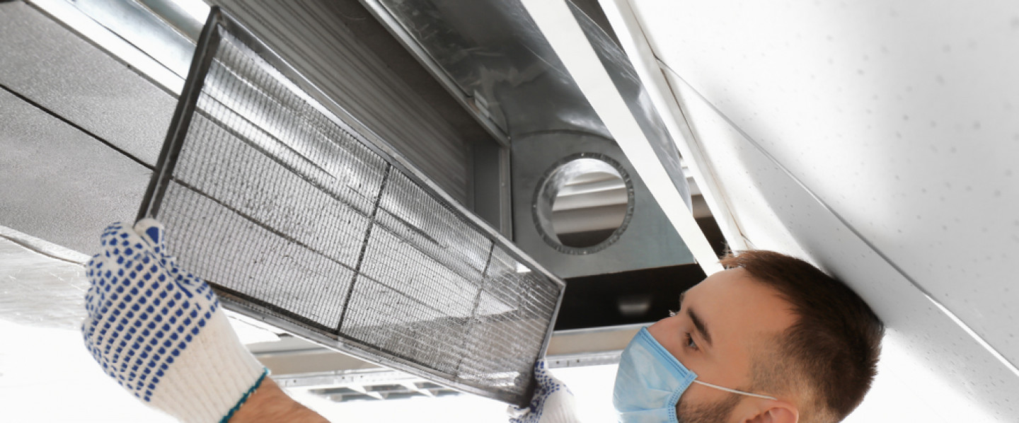 An HVAC contractor repairing an air conditioning system in San Antonio, TX